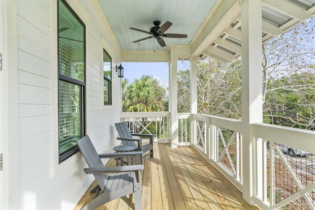 wooden terrace featuring ceiling fan and a porch