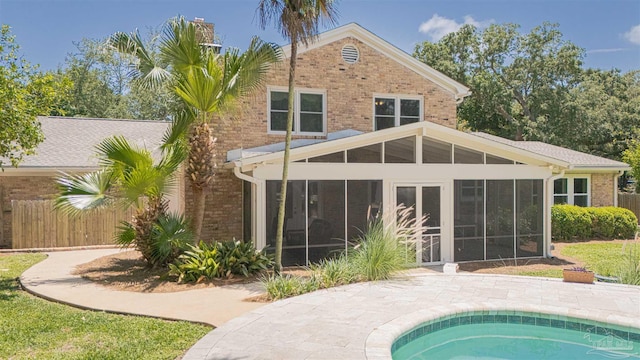 334 Andrew Jackson Trl, Gulf Breeze, FL 32561 - rear view of property with a sunroom and brick siding