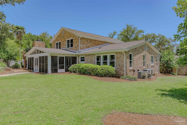 334 Andrew Jackson Trl, Gulf Breeze, FL 32561 - rear view of property with a sunroom, a chimney, brick siding, and a shingled roof