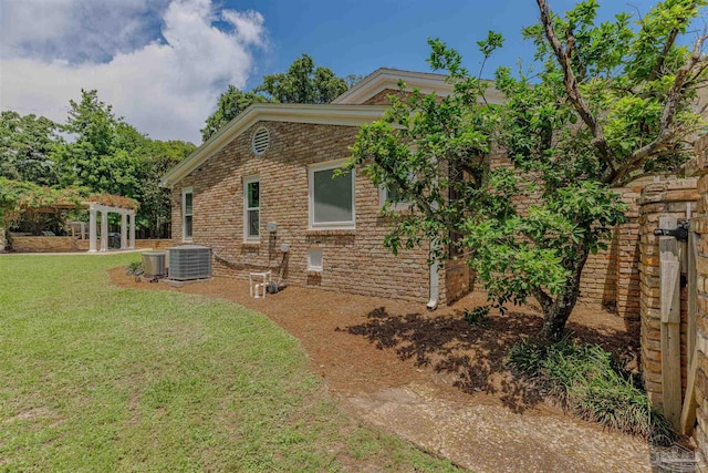334 Andrew Jackson Trl, Gulf Breeze, FL 32561 - rear view of house featuring a yard, cooling unit, a pergola, and brick siding