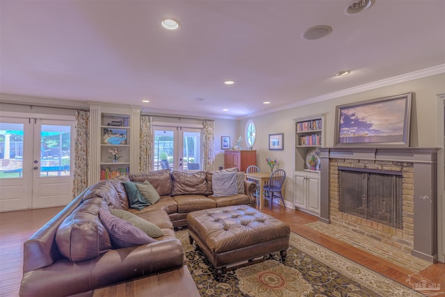 334 Andrew Jackson Trl, Gulf Breeze, FL 32561 - living area with french doors, ornamental molding, light wood finished floors, a fireplace with flush hearth, and built in features