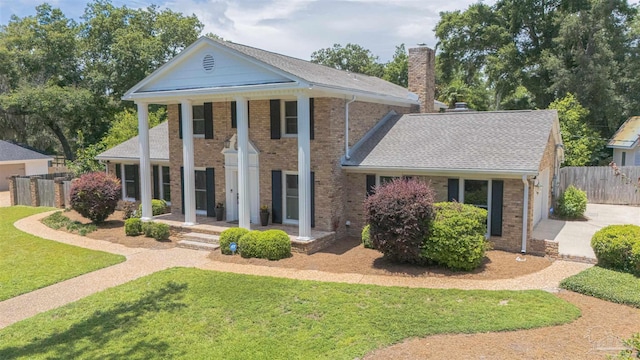 334 Andrew Jackson Trl, Gulf Breeze, FL 32561 - greek revival inspired property with a chimney, brick siding, concrete driveway, and a shingled roof