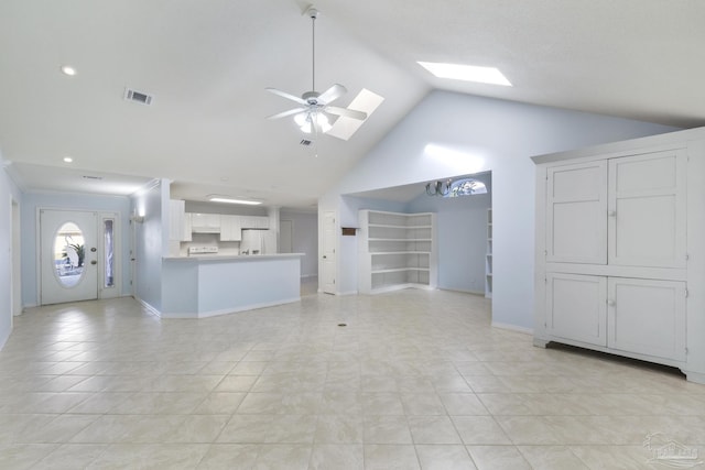 unfurnished living room with built in shelves, ceiling fan, a skylight, high vaulted ceiling, and light tile patterned floors