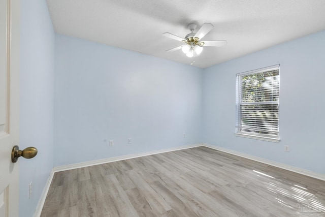 empty room with light wood-type flooring and ceiling fan