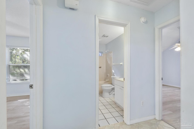 full bathroom with ceiling fan, hardwood / wood-style floors, toilet, vanity, and shower / bathtub combination