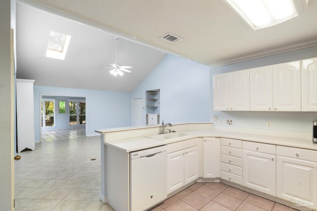 kitchen featuring kitchen peninsula, white cabinets, vaulted ceiling with skylight, sink, and dishwasher