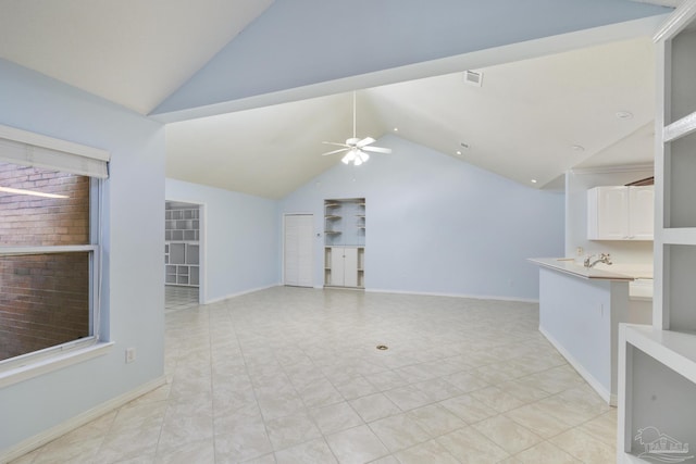 unfurnished living room with ceiling fan and lofted ceiling