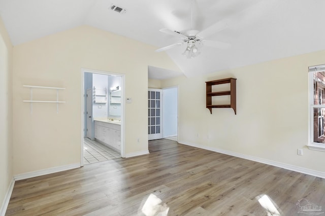 unfurnished living room featuring ceiling fan, lofted ceiling, and light wood-type flooring