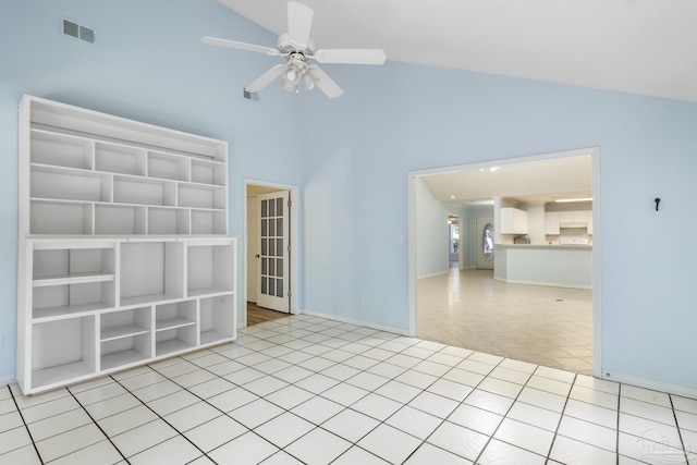 unfurnished room featuring ceiling fan, light tile patterned floors, and high vaulted ceiling