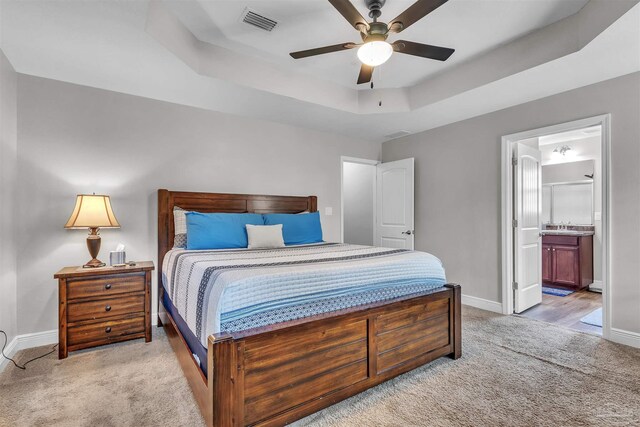 3818 Weatherstone Cir, Pensacola, FL 32507 - bedroom with light colored carpet, a raised ceiling, ensuite bathroom, and ceiling fan