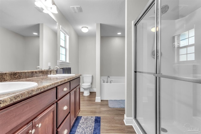 3818 Weatherstone Cir, Pensacola, FL 32507 - bathroom featuring double vanity, a stall shower, wood finished floors, a garden tub, and recessed lighting