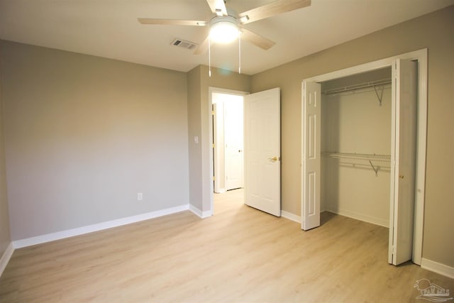 unfurnished bedroom featuring light hardwood / wood-style floors, a closet, and ceiling fan