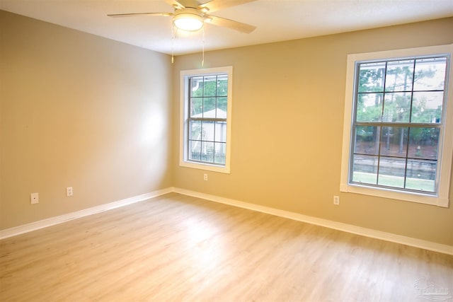 unfurnished room with light wood-type flooring and ceiling fan