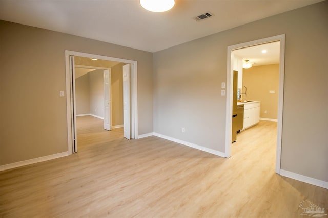 unfurnished room featuring light hardwood / wood-style floors