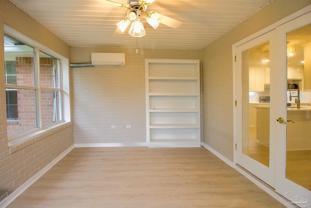 unfurnished sunroom with ceiling fan, wooden ceiling, and a wall mounted air conditioner