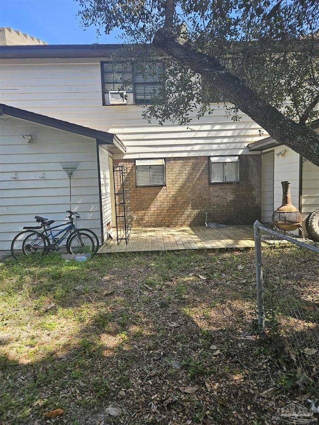 rear view of house with a deck and brick siding