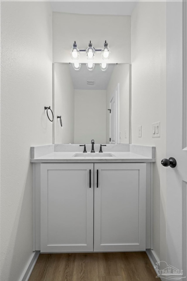 bathroom with vanity and wood-type flooring