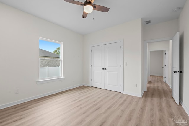 unfurnished bedroom with a closet, ceiling fan, and light wood-type flooring