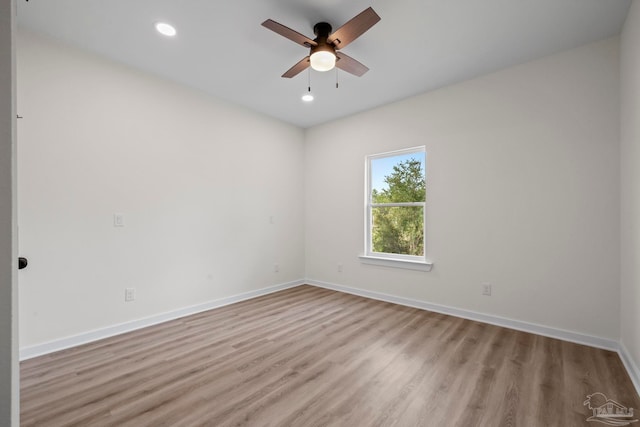 spare room with light hardwood / wood-style flooring and ceiling fan