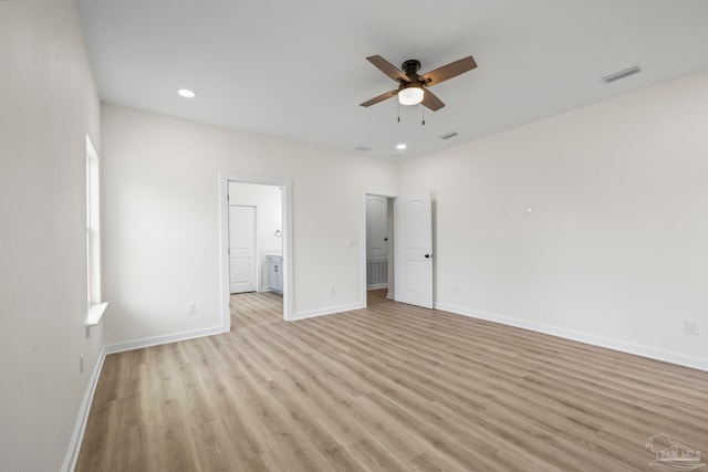 unfurnished bedroom featuring connected bathroom, ceiling fan, and light wood-type flooring