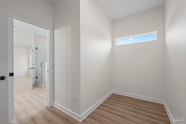 corridor with hardwood / wood-style floors