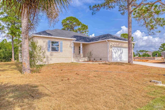 view of front of property with a front yard and a garage