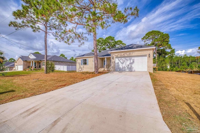 ranch-style home featuring a front lawn and a garage