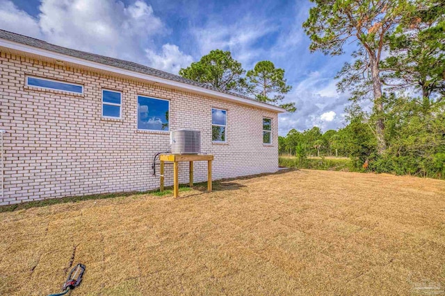 view of home's exterior featuring a yard and central air condition unit