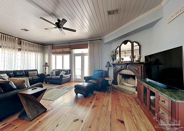 living room with wood ceiling, crown molding, ceiling fan, and wood-type flooring