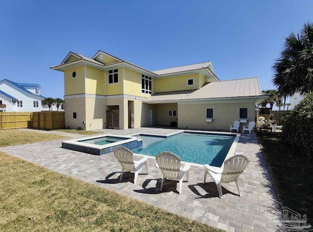 view of swimming pool featuring an in ground hot tub, a patio, and a yard