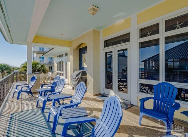 exterior space featuring a balcony, french doors, and a grill