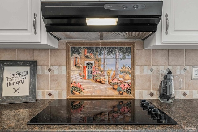 kitchen with white cabinetry, black electric cooktop, backsplash, and dark stone counters