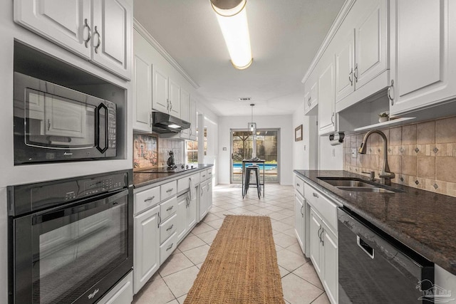 kitchen featuring light tile patterned floors, sink, white cabinetry, decorative light fixtures, and black appliances