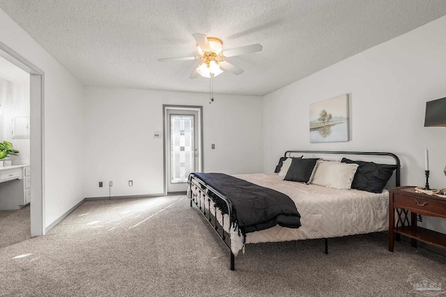 carpeted bedroom featuring ensuite bathroom, ceiling fan, access to outside, and a textured ceiling