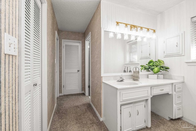 bathroom with a textured ceiling and vanity