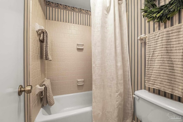 bathroom featuring shower / bath combo with shower curtain and toilet