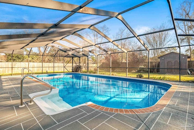 view of swimming pool with a storage unit, a lanai, and a patio area