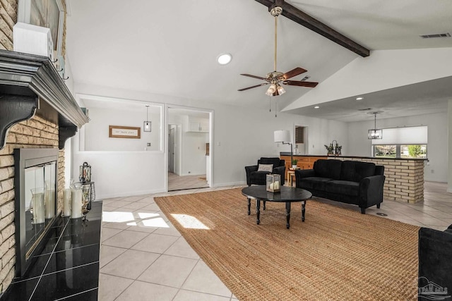 living room featuring vaulted ceiling with beams, ceiling fan, and light tile patterned floors