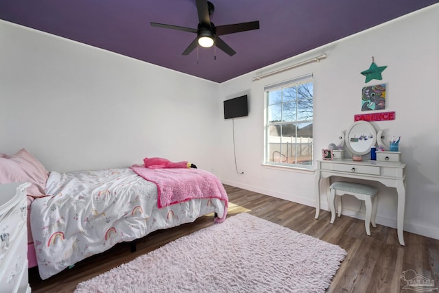 bedroom featuring dark hardwood / wood-style floors and ceiling fan