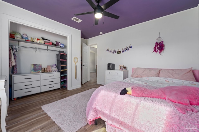 bedroom with a closet, ceiling fan, and wood-type flooring