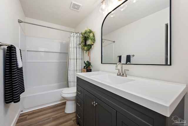 full bathroom featuring vanity, toilet, shower / tub combo with curtain, and hardwood / wood-style flooring