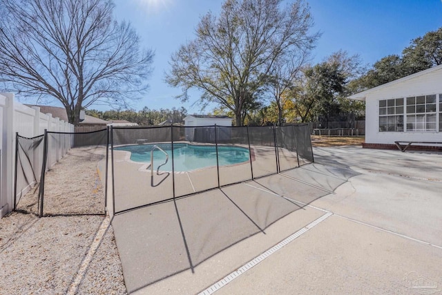 view of swimming pool featuring a patio area