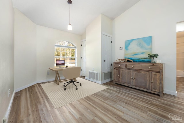 office space featuring light hardwood / wood-style flooring and vaulted ceiling