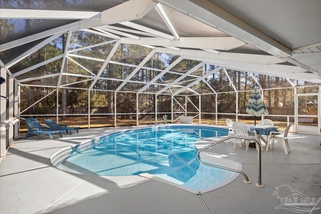 view of swimming pool featuring a lanai and a patio area