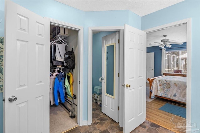 bedroom featuring ceiling fan, a closet, and a textured ceiling