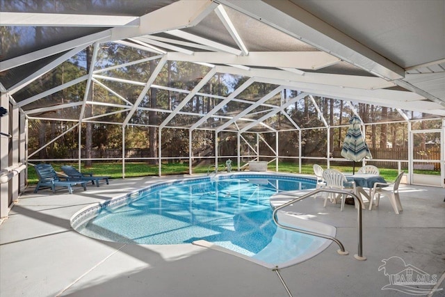 view of swimming pool featuring a patio and a lanai