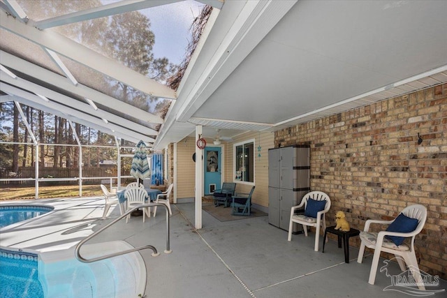 view of swimming pool with a lanai and a patio