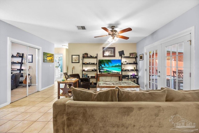 living room with french doors, light tile patterned flooring, and ceiling fan