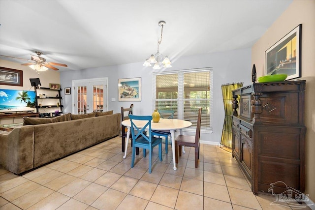 tiled dining room featuring french doors and ceiling fan with notable chandelier