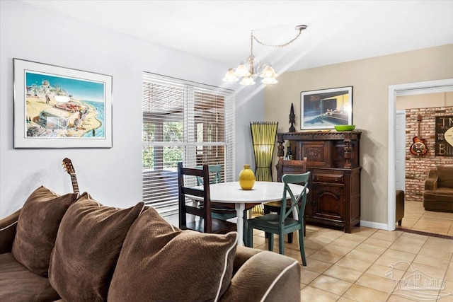 dining room with light tile patterned floors and a notable chandelier